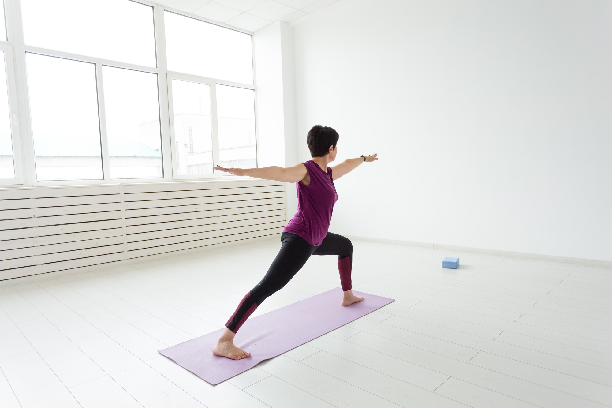 Yoga, people concept - a middle-aged woman doing a yoga and try to do a asana